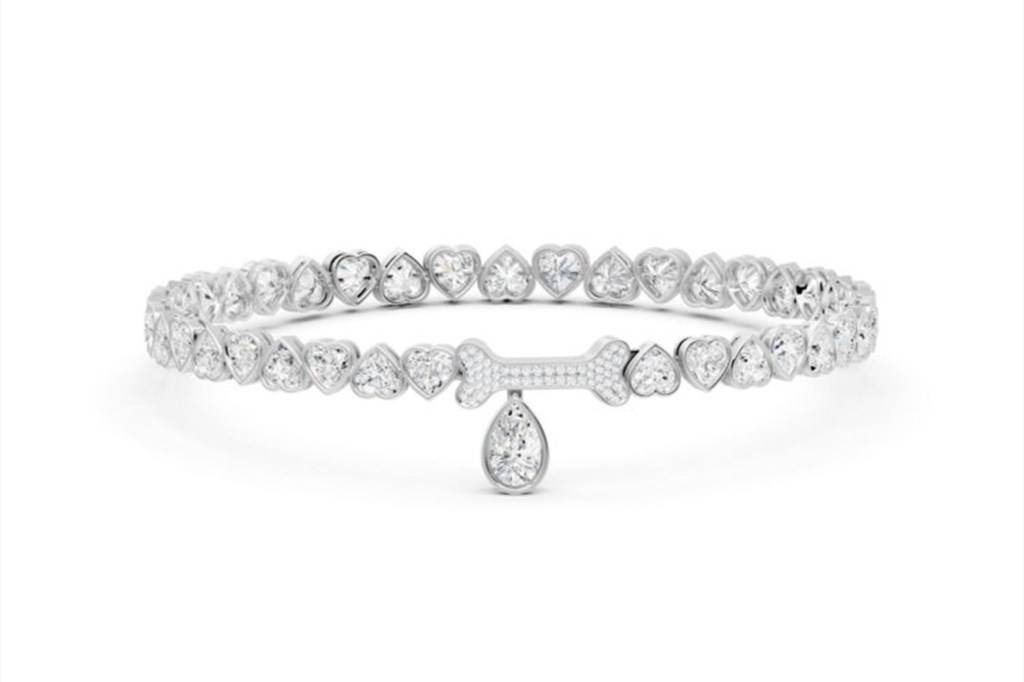 A diamond dog collar made of heart-shaped diamonds with a diamond-studded bone and tear-drop diamond pendant in the center.