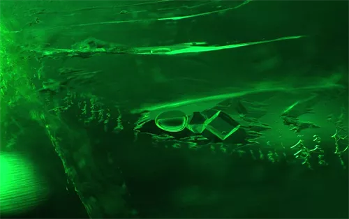 These are inclusions buried within emerald. Emerald is a member of the beryl family, its chemical composition being beryllium aluminium silicate.