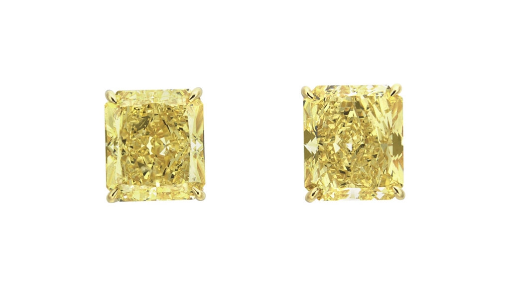 A cut-cornered rectangular modified brilliant-cut earrings, one is fancy-vivid yellow and weighs 5.23 carats, while the other is 5.12 carats and fancy-intense yellow at Christie's image