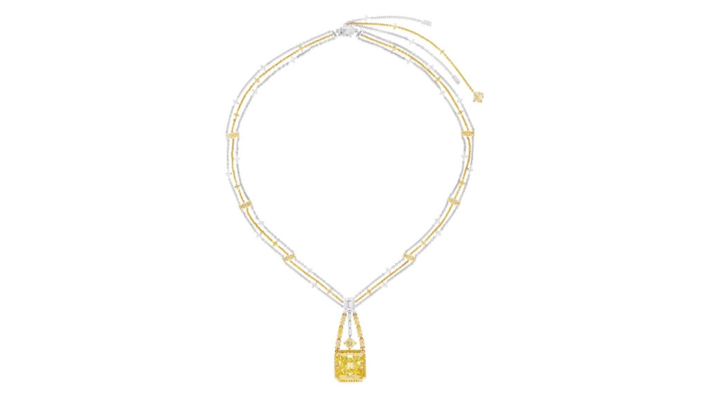 This necklace sports a cut-cornered square modified brilliant-cut, 20.04-carat, fancy-intense-yellow, VS1-clarity diamond, framed by brilliant-cut diamonds of yellow-tint. It hangs from a surmount and link-chain necklace set with an array of diamond cuts, including yellow-hued stones at Phillips image