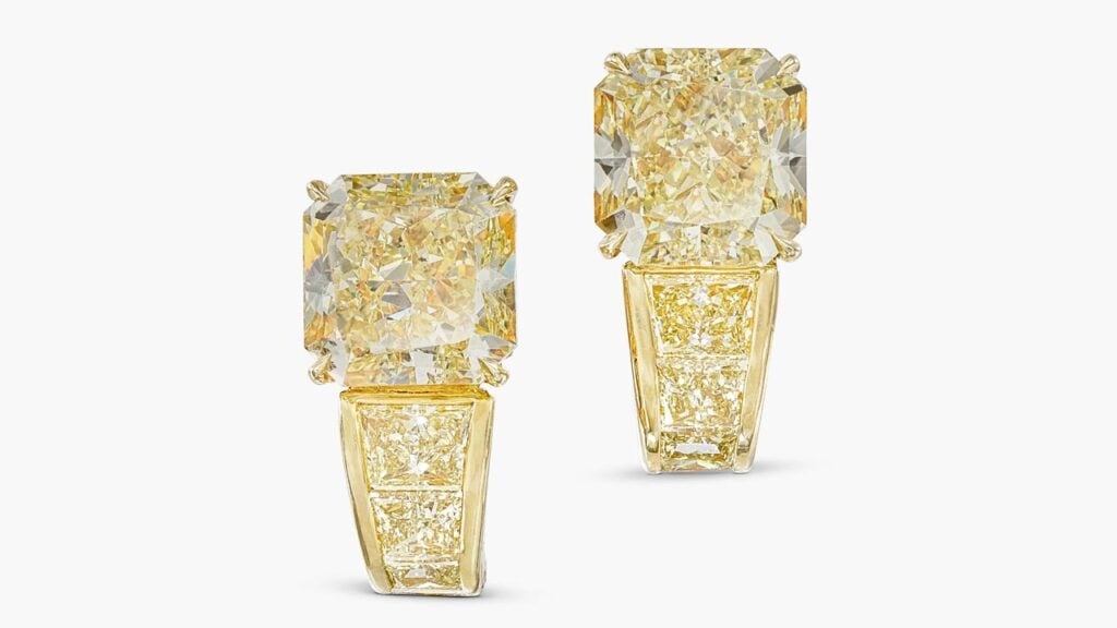 A pair of Cartier ear clips featuring two cushion-shaped, fancy-yellow diamonds, one a 5.01-carat, VS2 and the other a 5.03-carat, SI1 stone — and 2 to 3 carats of additional stones with a yellow tint at Sotheby's image