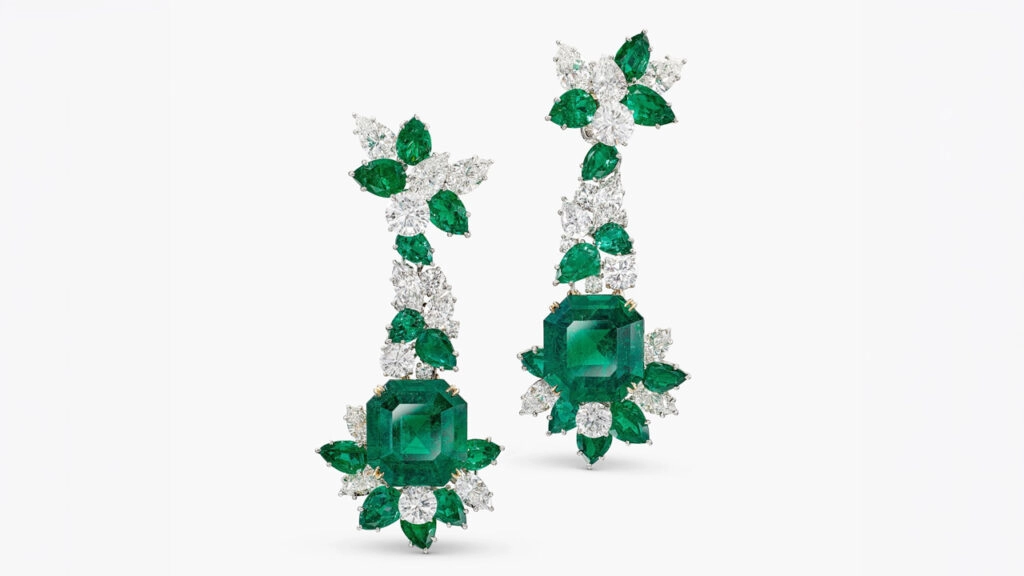 These Harry Winston cluster design earrings feature pear-shaped emeralds and pear-shaped and brilliant-cut diamonds suspending step-cut Colombian emeralds weighing 21.60 and 21.11 carats at Sotheby's image