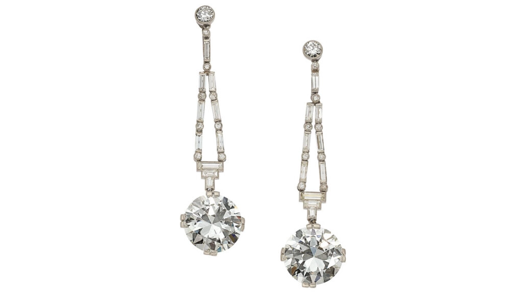 A pair of Art Deco diamond earrings sporting round brilliant-cut diamonds. One is a 5.16-carat, H, VS1 stone and the other a 5.08-carat, H, VS2 diamond, hanging from round brilliant, baguette and full-cut diamonds at Heritage Auctions image