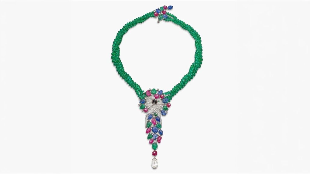 A Cartier tutti frutti necklace designed as a pair of embracing parrots, featuring brilliant-cut diamonds and a diamond briolette, as well as emeralds, mother-of-pearl, rubies and sapphires at Sotheby's image