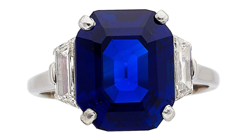 A ring centering an octagonal-shaped, 6.59-carat Kashmir sapphire between two trapezoid-shaped diamonds at Heritage Auctions image