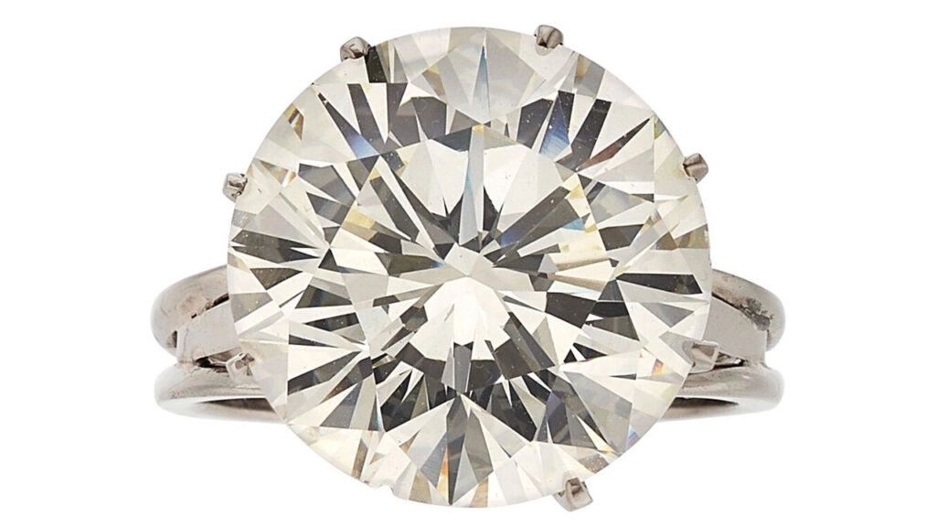 A ring centering a round brilliant-cut, 12.90-carat, M, VS2 diamond at Heritage Auctions image